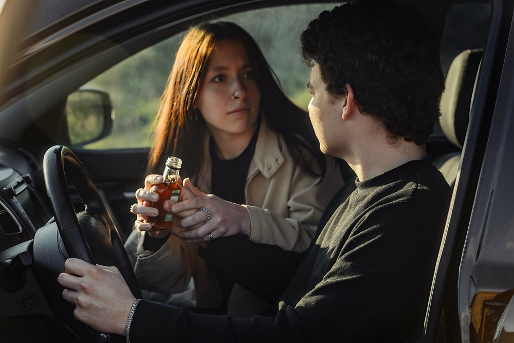 Passenger-drinks-alcohol-in-car