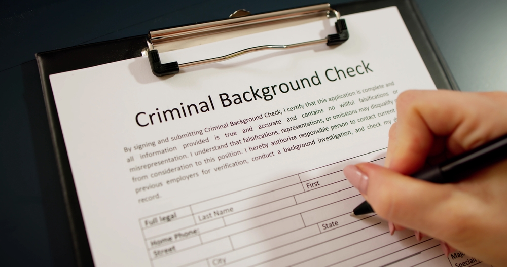 Applicant filling out a criminal background check. Learn how long a misdemeanor stays on your record.